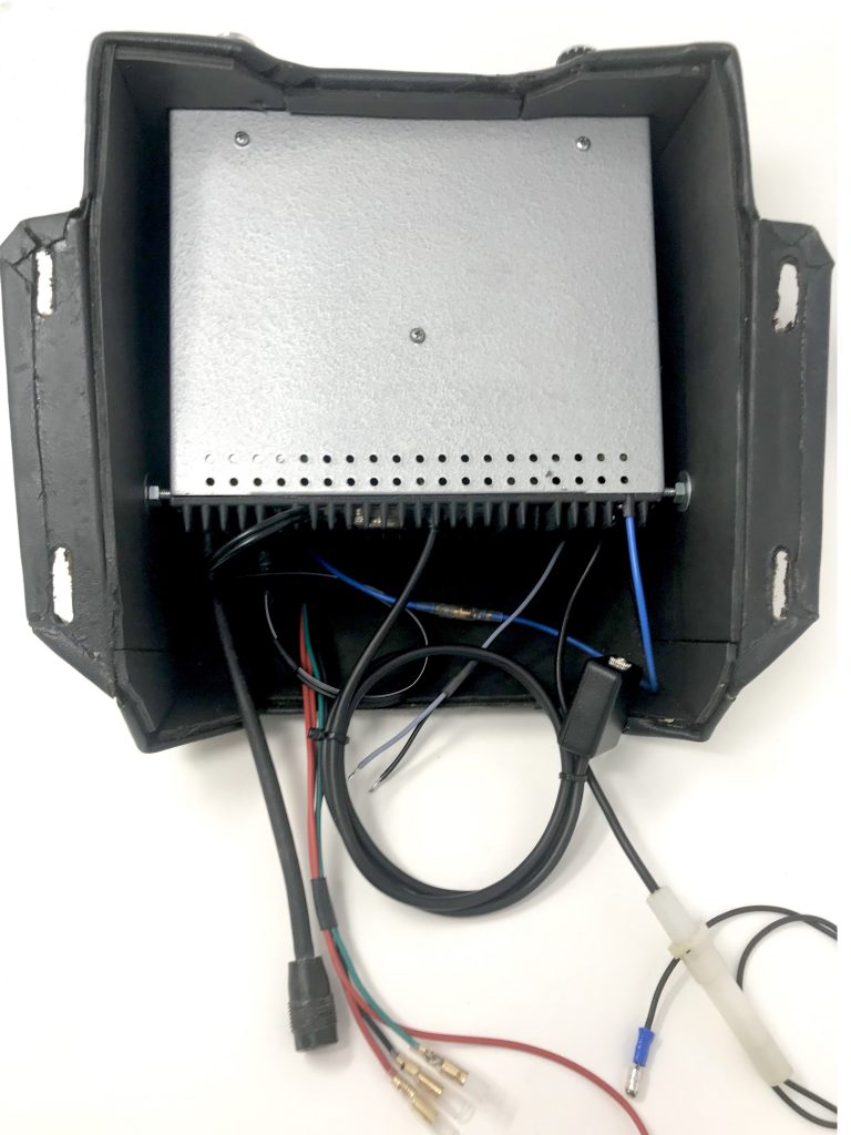 Aston Martin DB6 radio console showing restored Motorola 727 radio, wiring loom and AUX input cable.